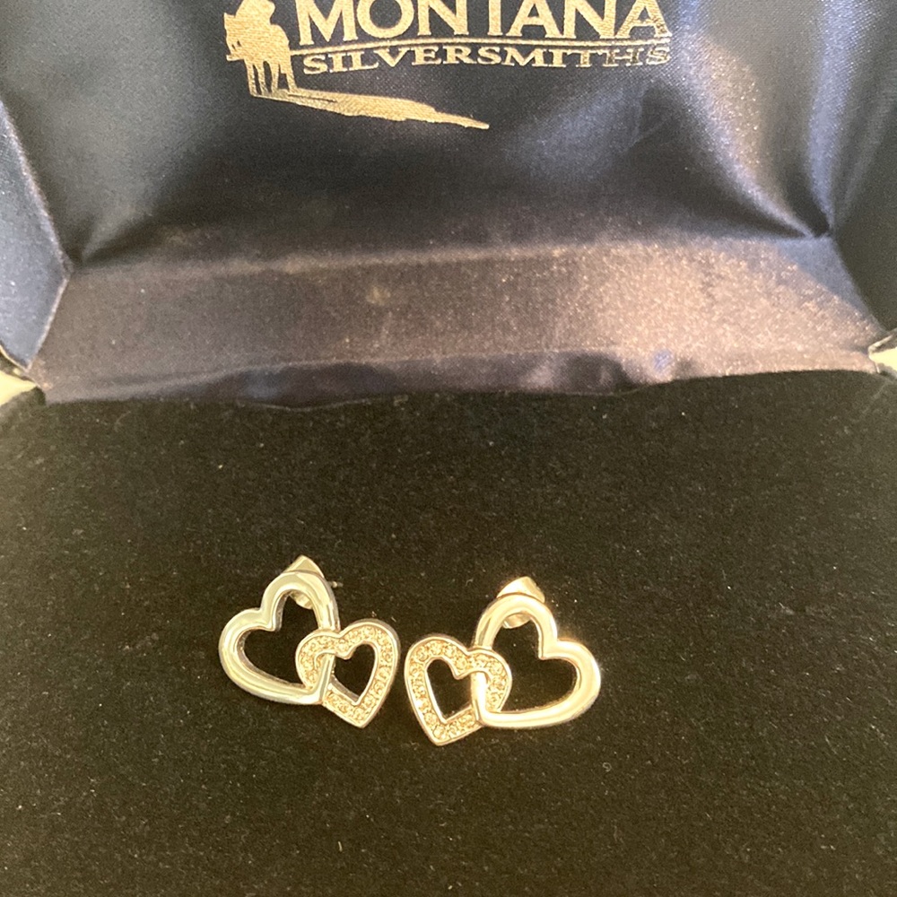 Silver heart earrings with crystal embellishments.